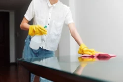 personnel nettoyant une table avec des produits biocides